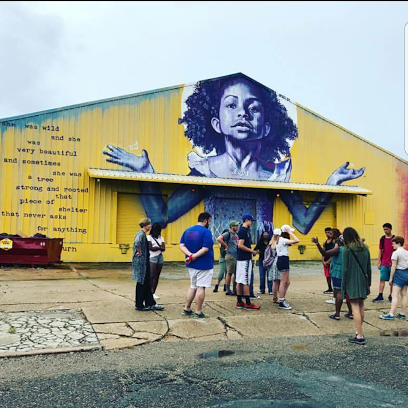 New Orleans youth group in front of building art